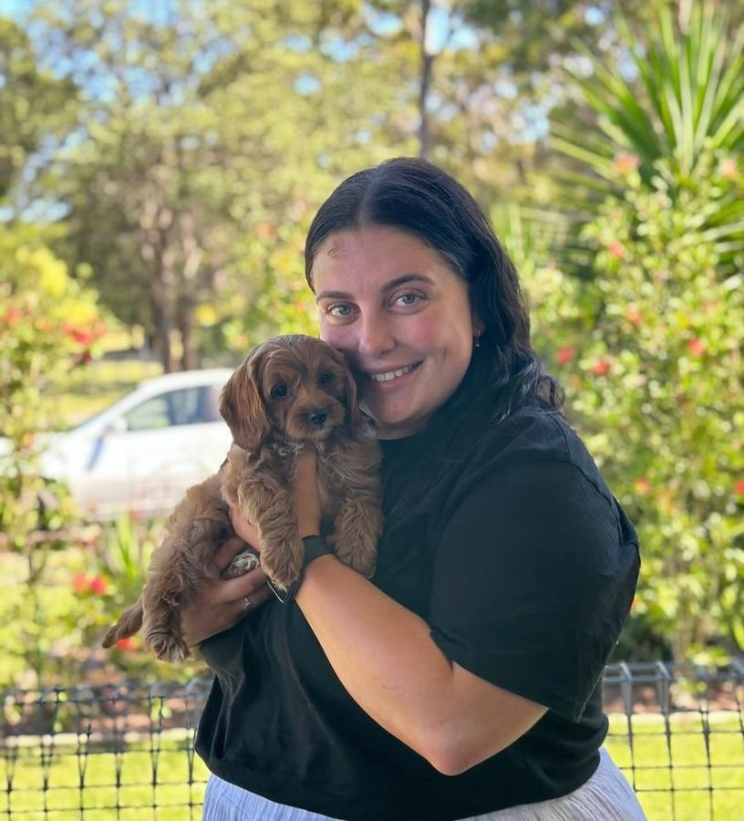 Photo of Amelia Woods with their Cavoodle