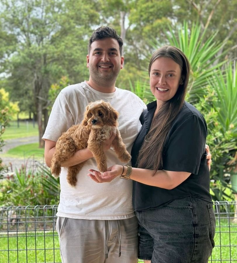 Photo of Jake and Mia Dawson with their Cavoodle